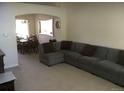Open living room featuring a sectional sofa and adjacent dining area at 13674 Plaster Cir, Broomfield, CO 80023