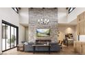 Spacious living room with stone fireplace and large windows at 8006 Trinity Peak Ln, Castle Rock, CO 80108