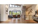 Open concept living room with stone fireplace and high ceilings at 8006 Trinity Peak Ln, Castle Rock, CO 80108
