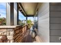 Covered porch with seating area and view of neighborhood at 1519 Stonehill Ct, Castle Rock, CO 80104