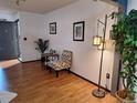 Light and airy entryway with wood floors and seating area at 3550 S Harlan St # 313, Denver, CO 80235