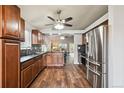 Modern kitchen with stainless steel appliances and hardwood floors at 11012 Blackwolf Ln, Parker, CO 80138