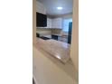 Modern kitchen with teal appliances and a breakfast bar at 1940 Quince St, Denver, CO 80220