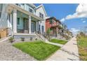 Two story home on a tree lined street with a walkway at 21278 E 63Rd Dr, Aurora, CO 80019