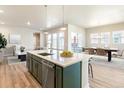 Modern kitchen with an island, stainless steel appliances, and an open floor plan at 21278 E 63Rd Dr, Aurora, CO 80019
