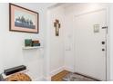 Bright entryway with wood floors, featuring framed artwork and religious iconography at 1160 S Monroe St, Denver, CO 80210