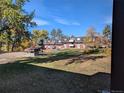 Apartment building with a grassy area in front at 140 E Highline Cir # 203, Centennial, CO 80122