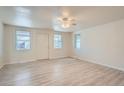 Spacious living room with light gray vinyl plank flooring and ceiling fan at 2332 W Baltic Pl, Englewood, CO 80110