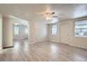 Open concept living room and dining area with vinyl flooring and lots of natural light at 2332 W Baltic Pl, Englewood, CO 80110