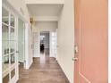 Bright entryway with hardwood floors and views to the living room at 6061 Miners Peak Cir, Frederick, CO 80516