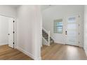 Bright entryway with hardwood floors and modern staircase at 42992 Colonial Trl, Elizabeth, CO 80107