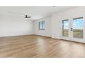 Spacious bonus room with hardwood floors and access to a balcony at 42992 Colonial Trl, Elizabeth, CO 80107
