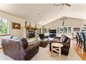 Spacious living room with fireplace and leather furniture at 8 Yuma Trl, Evergreen, CO 80439