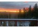 Spectacular sunset view from deck overlooking mountain landscape at 8 Yuma Trl, Evergreen, CO 80439