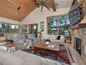 Living room with fireplace, large windows, and mountain views at 41 Barton Ridge Dr, Breckenridge, CO 80424