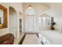 Bright and spacious entryway with high ceilings and tile flooring at 7379 S Ukraine St, Aurora, CO 80016