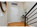 Bright and airy entryway with hardwood floors and modern staircase at 3040 Zuni St # C, Denver, CO 80211