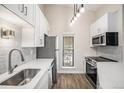 Modern kitchen with white cabinets, quartz countertops, and stainless steel appliances at 2800 Kalmia Ave # C314, Boulder, CO 80301