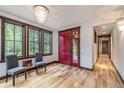 Bright entryway with hardwood floors, red door, and two gray chairs at 1003 Boreas Pass Rd, Breckenridge, CO 80424
