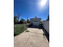 Detached garage with a paved driveway and green trash bin at 2080 Emporia St, Aurora, CO 80010