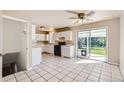 Kitchen features white cabinets, tile floor and sliding glass door at 752 S Union Blvd, Lakewood, CO 80228