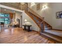 Grand entryway with hardwood floors and staircase at 6297 Ellingwood Point Way, Castle Rock, CO 80108