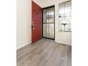 The entryway features light wood flooring and a red door with a security screen at 7900 W Layton Ave # 833, Littleton, CO 80123