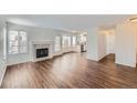 Bright living room with hardwood floors, fireplace, and view of the kitchen at 5363 E Weston Ave, Castle Rock, CO 80104