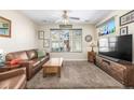 Living room with leather sofa, wood coffee table, and large TV at 1851 S Buchanan Cir, Aurora, CO 80018