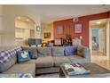 Spacious living room with sectional sofa, hardwood floors, and access to other rooms at 9448 E Florida Ave # 1078, Denver, CO 80247