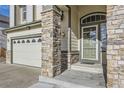 Inviting front entrance with stone pillars and a covered porch at 12946 Kearney St, Thornton, CO 80602