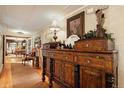 Hallway with antique furniture and view into other rooms at 27425 Spruce Ln, Evergreen, CO 80439