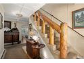 Wooden staircase with rustic railing leading to upper floor at 27425 Spruce Ln, Evergreen, CO 80439