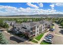 Aerial view of a townhouse community with mountain views and ample parking at 1646 S Deframe St # A1, Lakewood, CO 80228