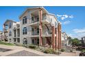 Two-story townhouse exterior, featuring brick accents and balconies at 1646 S Deframe St # A1, Lakewood, CO 80228