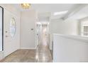 Bright entryway with tile flooring, leading to hallway with access to other rooms at 1151 S Nome St, Aurora, CO 80012