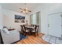 Bright dining area with hardwood floors and seating for six at 18872 E Prentice Pl, Centennial, CO 80015