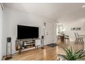 Entryway with hardwood floors, modern media console, and view to dining area at 15195 E 16Th Pl # 204, Aurora, CO 80011