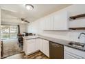 Modern kitchen with white cabinets, granite countertops, and stainless steel appliances at 735 S Alton Way # 3A, Denver, CO 80247