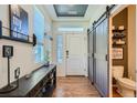 Bright and spacious entryway with barn door to powder room and console table at 249 S Old Hammer St, Aurora, CO 80018