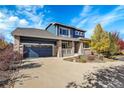 Two-story house with a charming front porch and attached garage at 5718 W Euclid Pl, Littleton, CO 80123