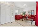 Cozy living room featuring red couches and a coffee table at 6470 S Ider St, Aurora, CO 80016