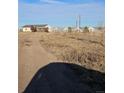 House with large yard and greenhouses in background at 41321 E 88Th Ave, Bennett, CO 80102