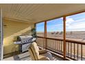 Relaxing screened porch with grill and outdoor seating at 41321 E 88Th Ave, Bennett, CO 80102