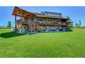 Luxury home with expansive deck and professionally landscaped lawn at 934 S Perry Park Rd, Sedalia, CO 80135