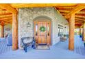 Inviting front entrance with wood door and stone accents at 934 S Perry Park Rd, Sedalia, CO 80135