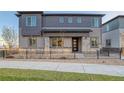 Two-story home with gray siding, stone accents, and a landscaped front yard at 23941 E 40Th Ave, Aurora, CO 80019