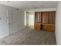 Living room with carpeted floors and built-in wooden cabinetry at 912 S Peoria St, Aurora, CO 80012