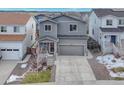 Two-story house with gray siding, two-car garage, and small yard at 3536 Evening Pl, Castle Rock, CO 80109