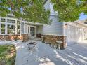 Two-story house with stone accents and front patio at 12689 S Creekside Ct, Parker, CO 80134